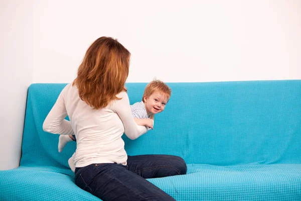 Матір з сином, граючи на дивані — стокове фото
