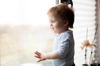 Sevimli küçük çocuk pencereden bakıyor