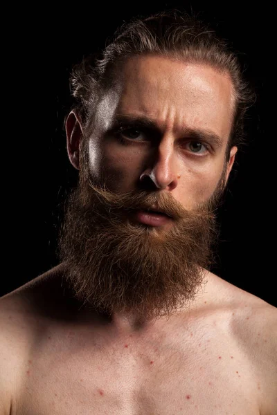 Tattooed bearded hipster on black background — Stock Photo, Image