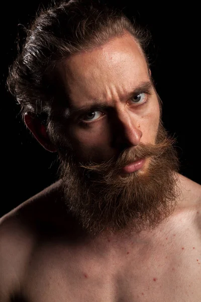 Portrait of tattooed bearded hipster on black background — Stock Photo, Image