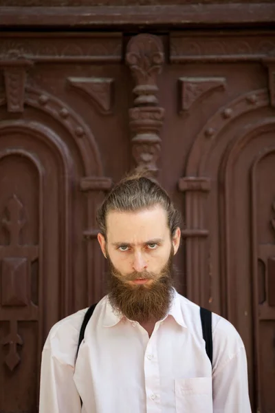 Hipster with long beard looking at the camera — Stock Photo, Image