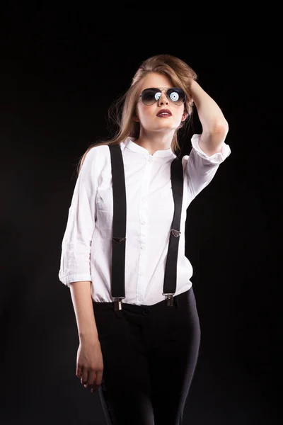 Blonde woman model with suspenders and white shirt