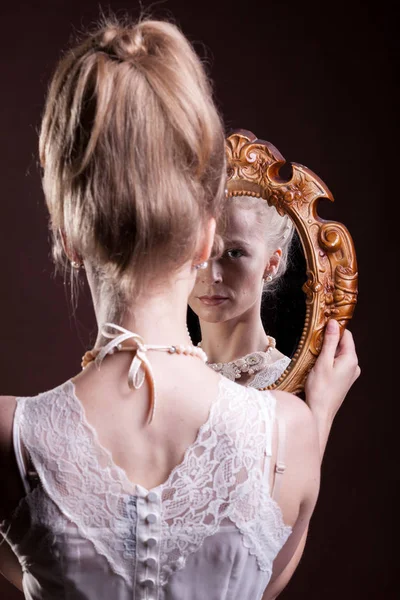 Blonde woman in victorian dress holding a mirrod in hands — Stock Photo, Image