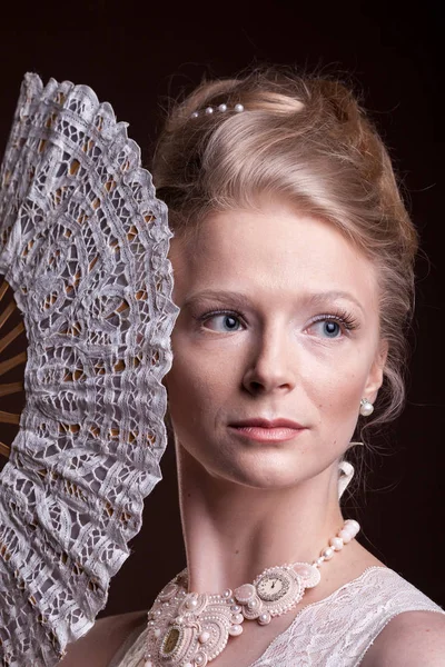 Woman in vintage victorian dress with a oriental fan in hand — Stock Photo, Image