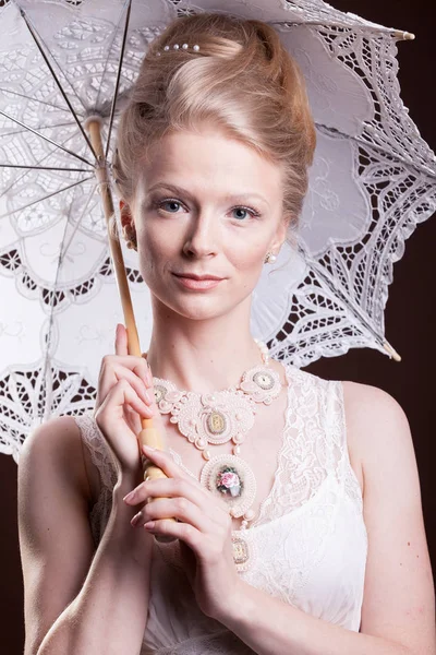 Portrait of woman in vintage dress holding a lace umbrella — Stock Photo, Image