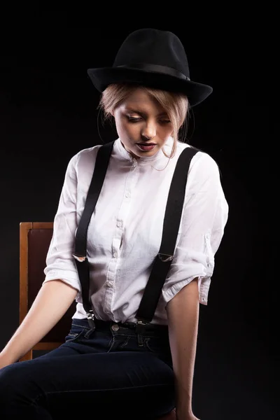 Gorgeous blonde model with suspenders and white shirt wearing a — Stock Photo, Image