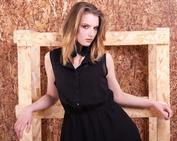 Portrait of woman fashion style posing on wooden wall