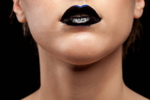 Close up of woman lips with black lipstick