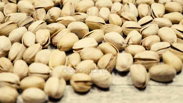 Over top view of Pistachios on wooden background — Stock Video