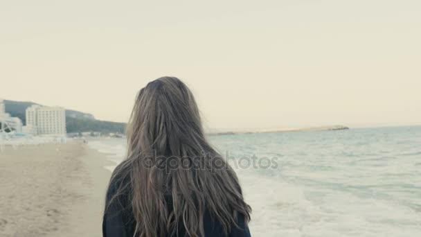 Kobieta w czarny szalik długo macha, chodzenie na wybrzeżu — Wideo stockowe