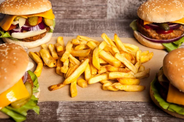 Delicious tasty burgers on wooden background