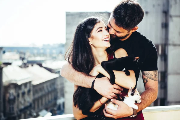 Vintage tonned image of happy couple holding their cats — Stock Photo, Image