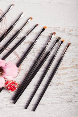 Kozmetik ve makyaj ürünleri ve aksesuarları Beyaz ahşap zemin üzerinde