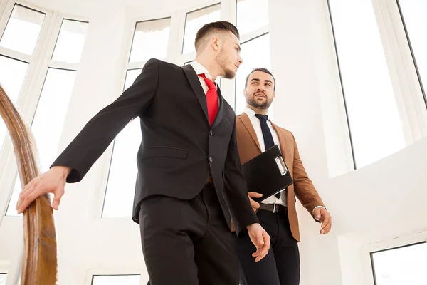 Business partners in formal suit walking and talking — Stock Photo, Image