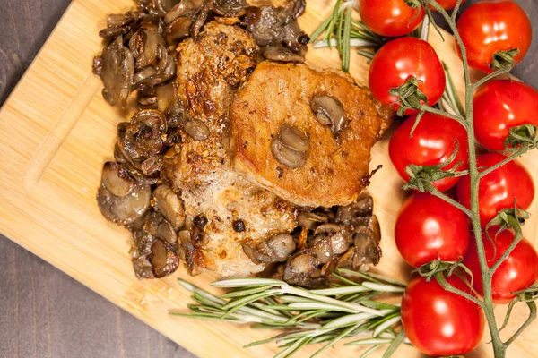 stock image Top view on grilled pork and mushrooms next to cherry tomatoes