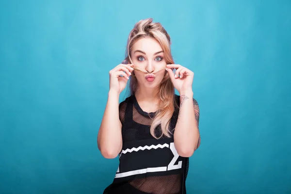 Beautiful blonde woman making a hair mustache and silly faces to — Stock Photo, Image