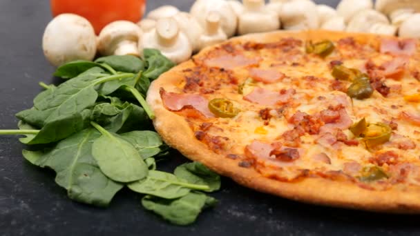 Leaves of baby spinach falling on fresh baked pizza — Stock Video