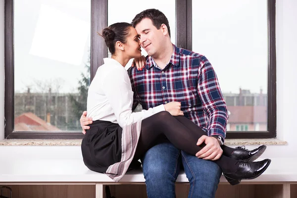 Inlove man and woman sitting together next to a big window — Stock Photo, Image