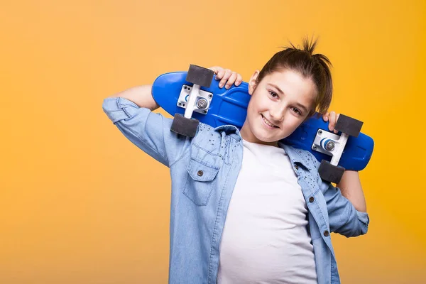 Adolescente chica con un monopatín en los hombros —  Fotos de Stock