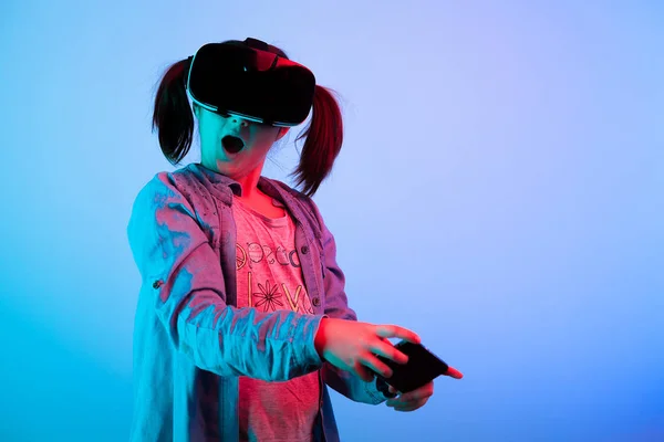 Surprised young girl playing virtual game