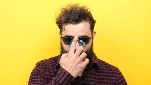 Long bearded man puts his sunglasses on from the top of his nose — Stock Video