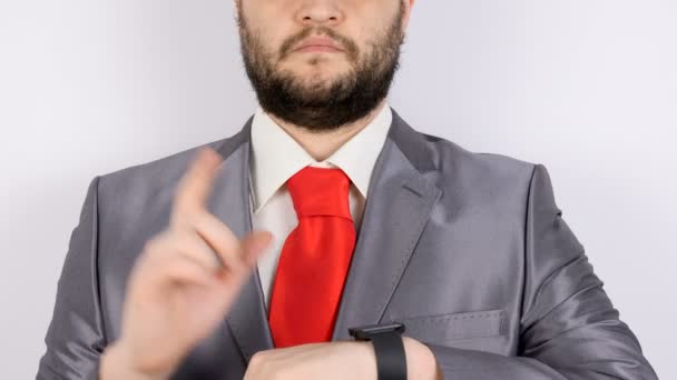 Businessman in suit tapping the display of smartwatch — Stock Video