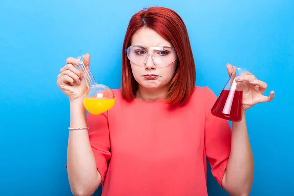 Nerd confundido científico mujer usando gafas protectoras y hol —  Fotos de Stock