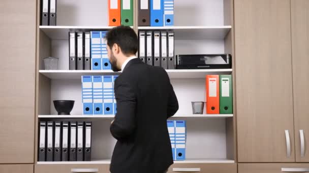 Après de longues heures de travail, l'homme d'affaires se relaxe en dansant au bureau — Video