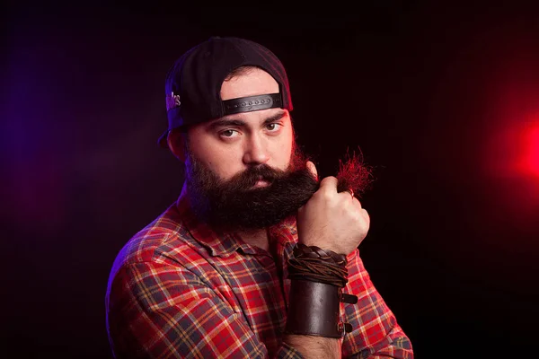 Angry bearded hipster man holding his beard in hands — Stock Photo, Image