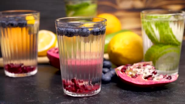 Water with infused blueberries, pomegranate and lemon — Stock Video