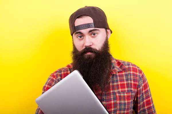Portrait d'un étudiant à longue barbe avec un ordinateur portable dans les mains — Photo