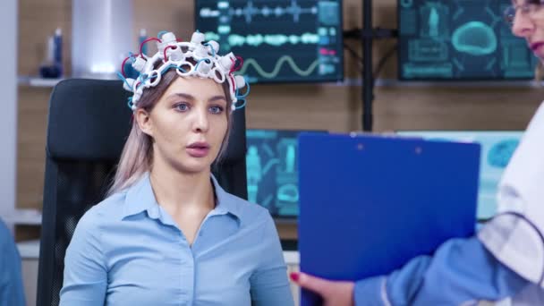 Paziente femminile che legge i dati cerebrali dagli appunti tenuti dal medico femminile — Video Stock