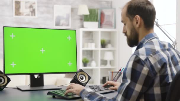Człowiek patrzy na zielony ekran PC wyświetlacz w dobrze oświetlonym domu — Wideo stockowe