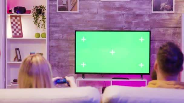 Zoom in der Wirkung von jungen Paar spielen Online-Spiele auf dem Sofa sitzen — Stockvideo