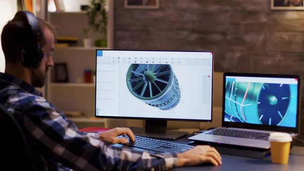 Side view of engineer wearing headphones and working on a turbine — Stock Photo, Image