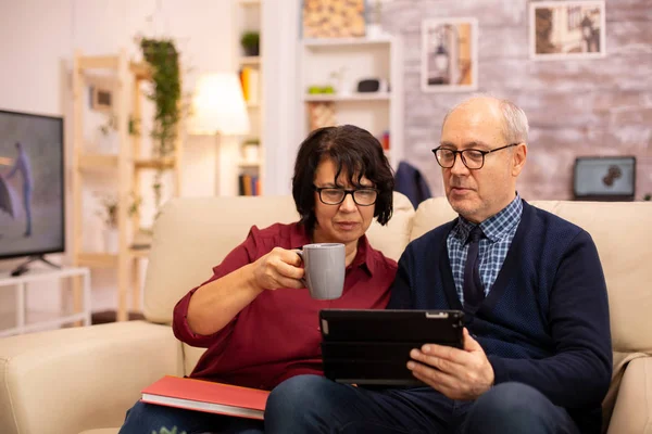 Mooi oud paar met behulp van een digitale tablet om te chatten met hun familie — Stockfoto