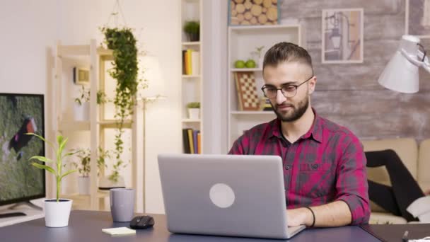 Freelancer bierze łyk kawy podczas pracy na laptopie — Wideo stockowe