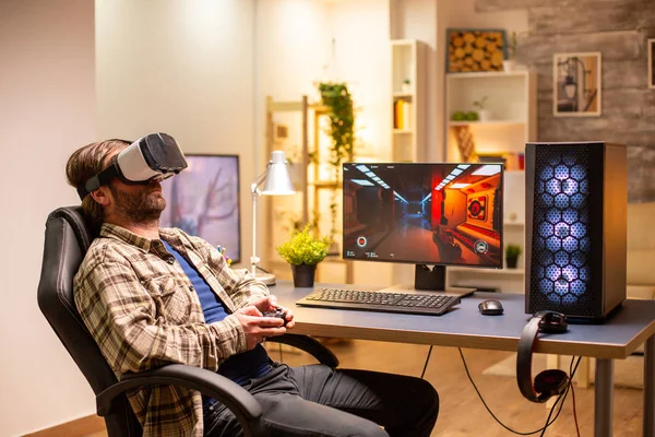 Professional gamer man using VR headset to play on powerful PC