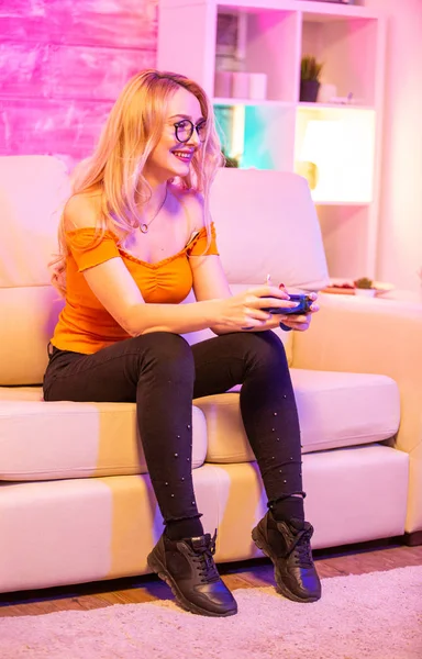 Beautiful blonde girl excited while playing video games — Stock Photo, Image
