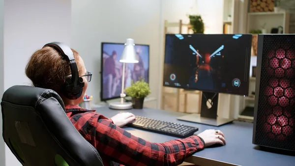 Side view of young female playing shooter games — Stock Photo, Image