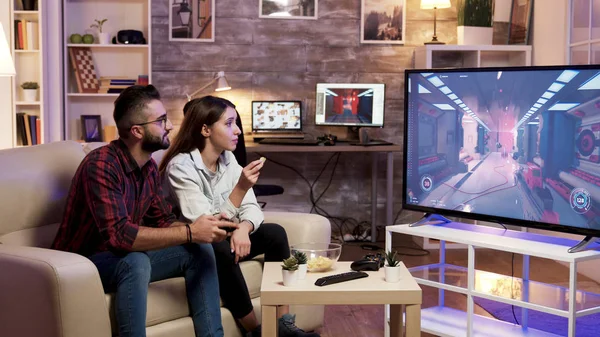 Girl eating chips while boyfriend is playing video games
