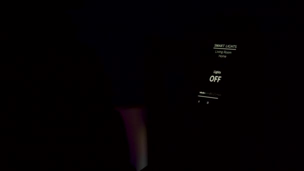 Человек держит смартфон с голосовой активацией приложение Smart Light, чтобы включить свет в доме — стоковое видео
