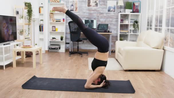 Belle jeune femme exécutant tête stand — Video