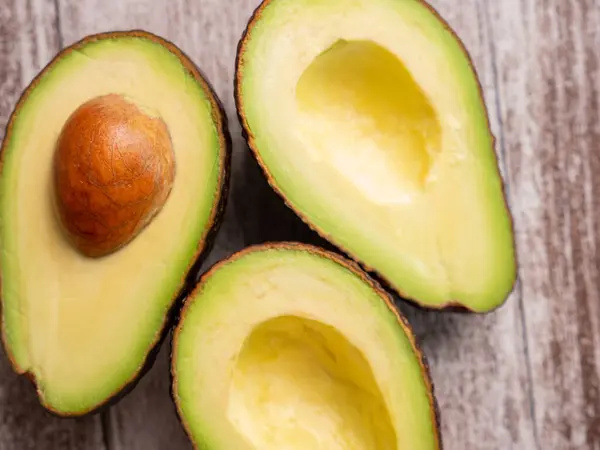 Top view fresh cutted avocado on wooden board — 스톡 사진