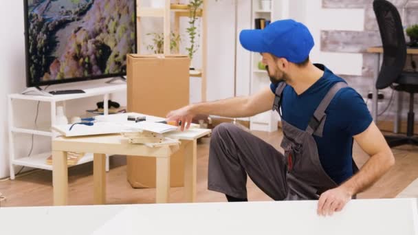 Professional furniture assembly worker checking position of the shelf — Stock Video