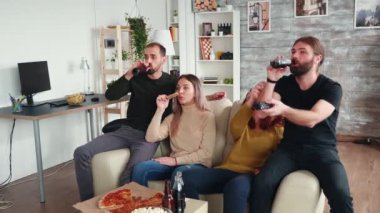 Bir grup yakın arkadaş bira ve pizzanın tadını çıkarıyorlar.