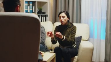 Zoom in shot of angry young wife at couple therapy