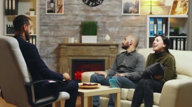 Angry man so mad at couple therapy trying to hit his wife