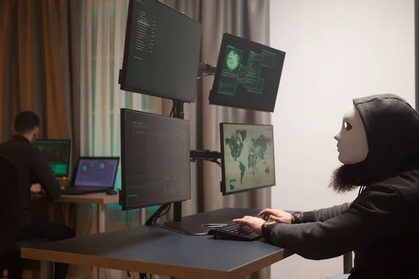 Cyber criminal wearing a white mask while testing government system — Φωτογραφία Αρχείου