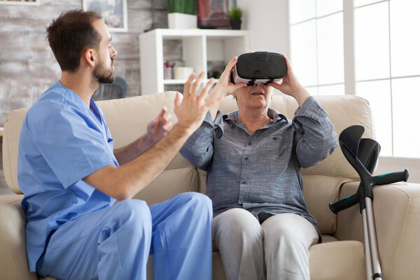 Elderly aged woman using virtual reality glasses